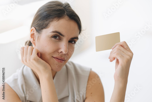 Confident businesswoman holding business card at office photo