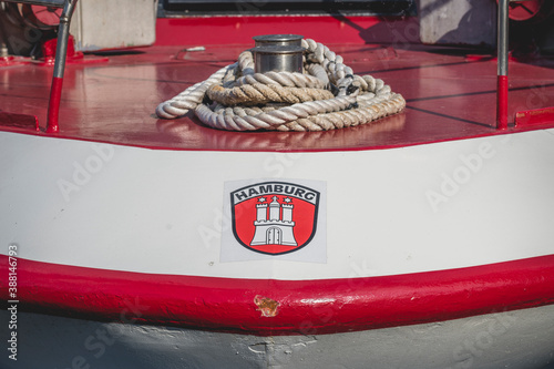 Germany, Hamburg, Rope around bollard on quayside with Hamburg sign photo