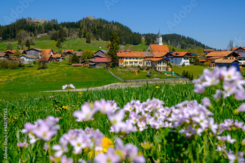 Germany, Bavaria, Zell, Meadow in front of countryside village in spring photo