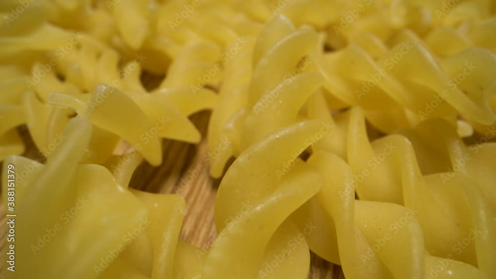 Dolly ahead macro shot of spiral Italian pasta. Raw macaroni. Vertical and smooth movement slide on the macaroni. Close up shot. Dolly ahead macro shot of spiral Italian pasta. Raw macaroni. Vertical and smooth movement slide on the macaroni. Close up shot.