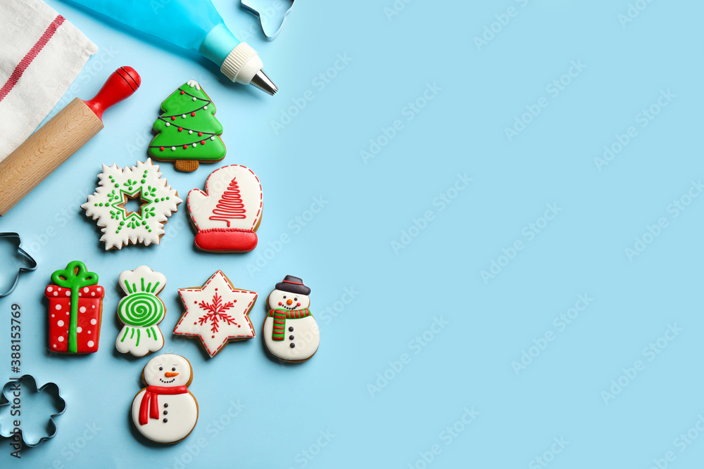 Flat lay composition with delicious gingerbread cookies and kitchen items on light blue background. Space for text