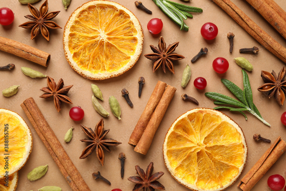 Different mulled wine ingredients on brown background, flat lay