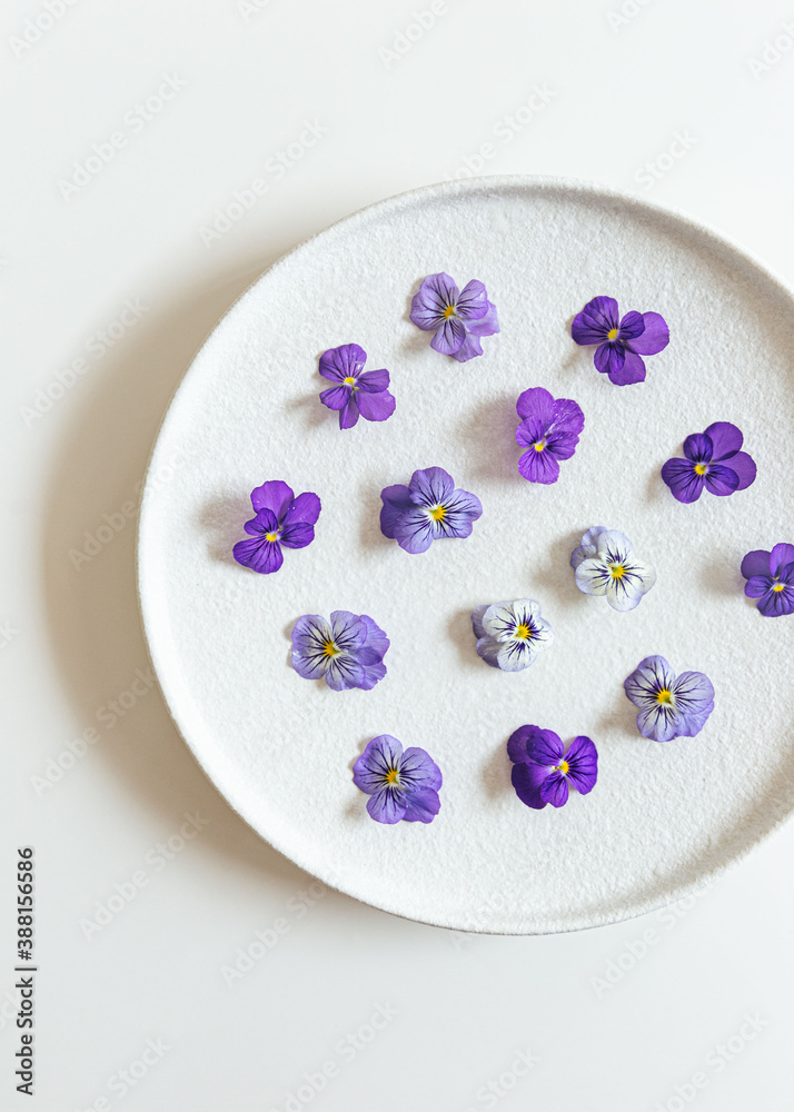 edible purple Violets on ceramic plate edible purple Violets on ceramic plate