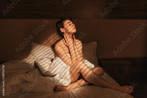 Nude female resting on bed photo