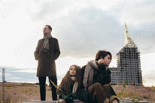 Woman, child and man on wasteland