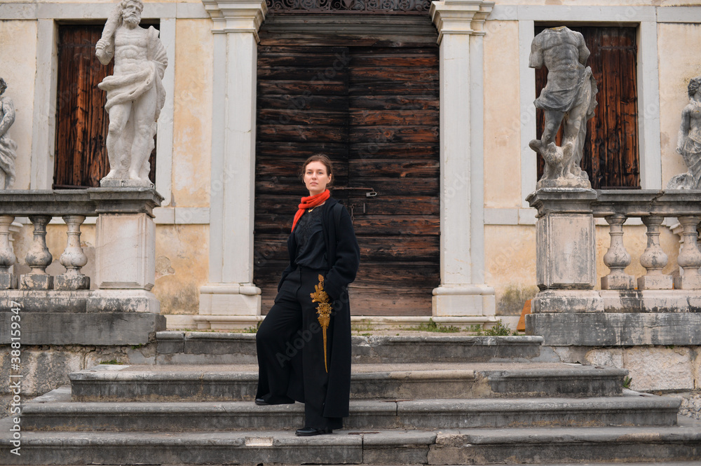 A beautiful portrait of an elegant woman on a stairs of a villa A beautiful portrait of an elegant woman on a stairs of a villa