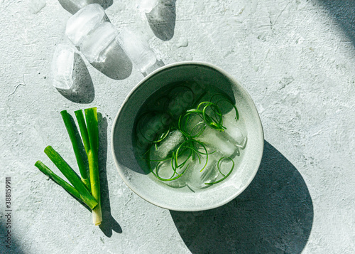Sliced green onion garnish in ice water