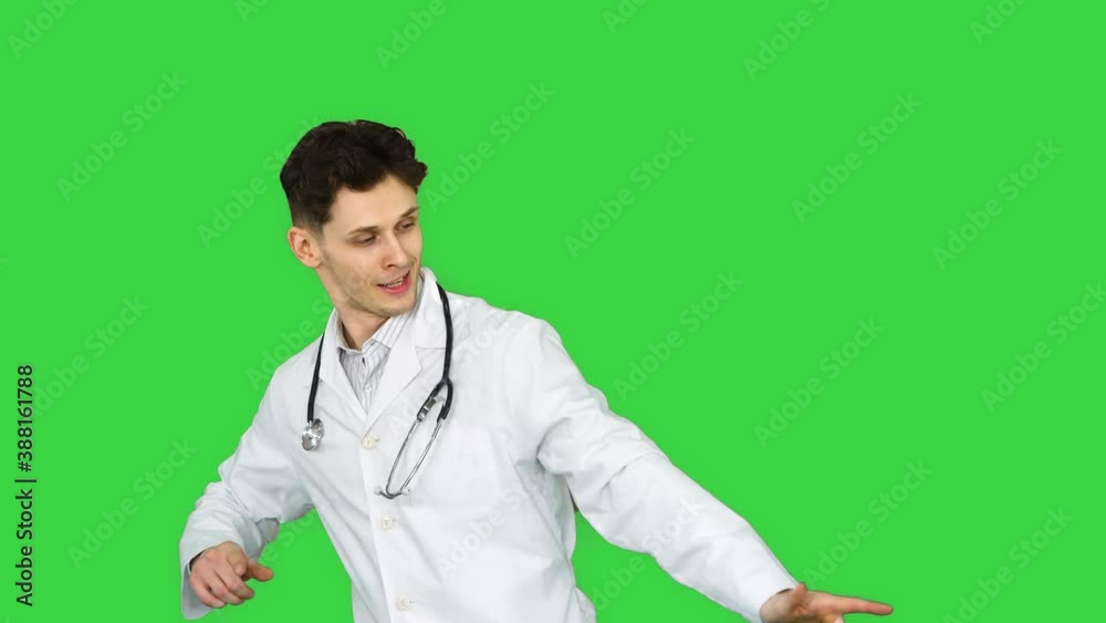 Young doctor wearing lab coat dancing on a Green Screen, Chroma Key. Young doctor wearing lab coat dancing on a Green Screen, Chroma Key.