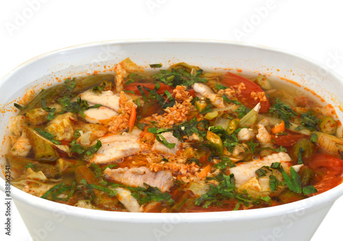 Bowl of spicy seafood soup on white