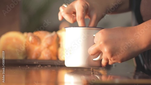 Woman's hand eating atole with pan de muerto. Day of the dead, Mexican tradition. photo