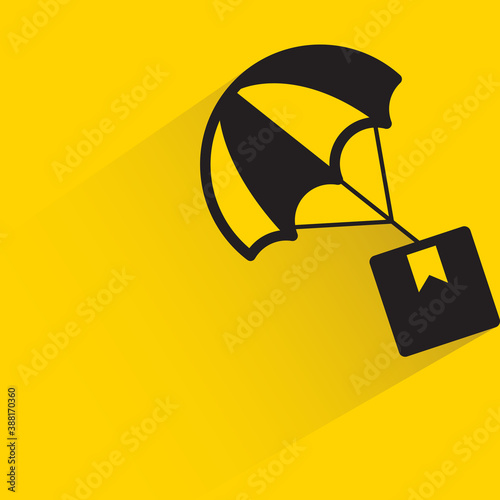 box and parachute with drop shadow on yellow background