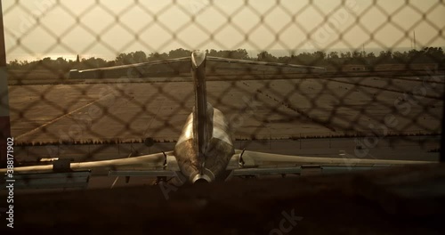 airplane on ground behind barbed wire netting, old abandoned airplane cinematic establishment shot, Athens Elliniko airport loneliness photo