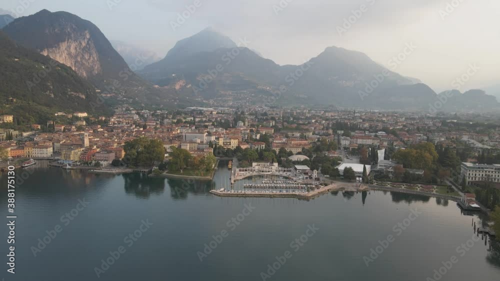 Riva Del Garda City, Italy. Aerial View of Lago Di Garda Lakefront on Summer Morning, Drone Shot Riva Del Garda City, Italy. Aerial View of Lago Di Garda Lakefront on Summer Morning, Drone Shot