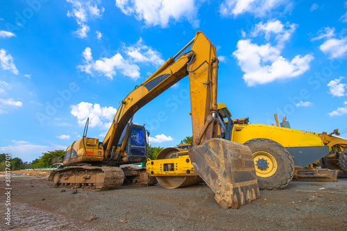 Backhoe  grader and road roller on the ground at site construction.