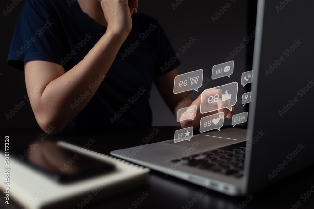 Woman working on laptop with emoticon bubble. Woman working on laptop with emoticon bubble.
