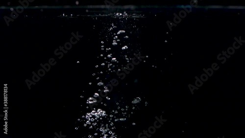 Abstract Stones Falling into Water in Slow Motion with Lots of Bubbles photo