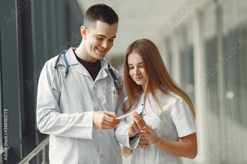 Doctor is sharing pills in hands. The doctors are discussing different tablets .