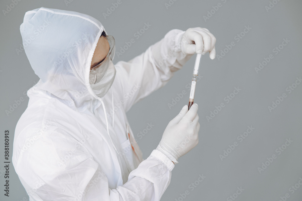 Corona virus theme. Man in a protective suit. Doctor use a syringe. Corona virus theme. Man in a protective suit. Doctor use a syringe.