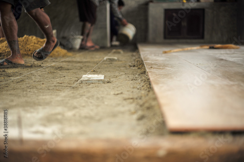 Spot focus on the floor at the construction site during installation of floor tiles