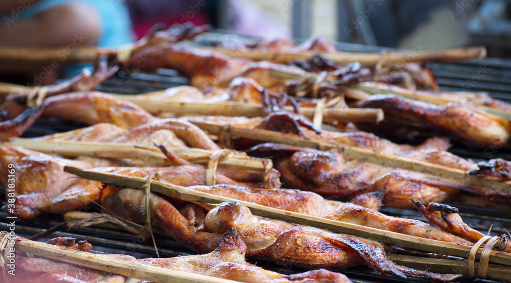 Roast chicken is on the stove, using charcoal to cook.