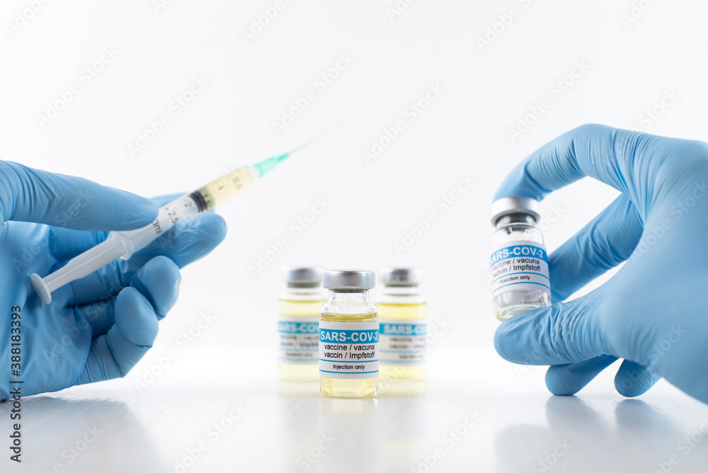 scientist in laboratory with syringe and vaccine scientist in laboratory with syringe and vaccine