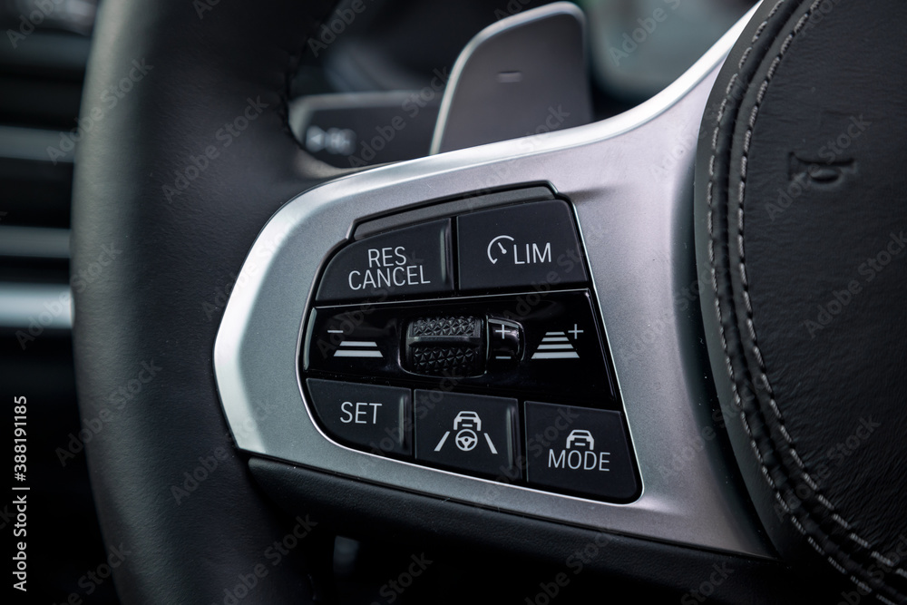 Vehicle interior of a modern car with control button.  Steering wheel with multifunction buttons