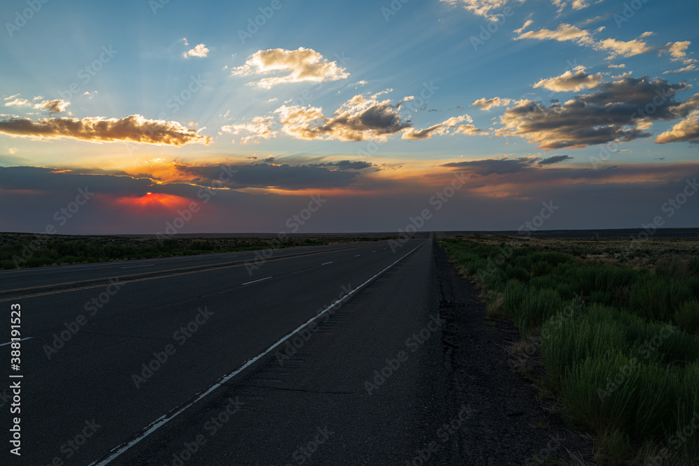 Landscape scene and sunrise above road. Highway road.
