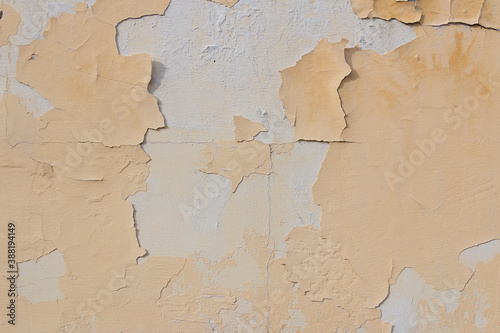 the surface of the old wall with the paint flying off
