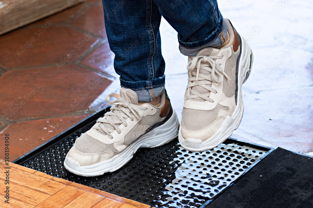 A pair of feet are disinfected A pair of feet are disinfected