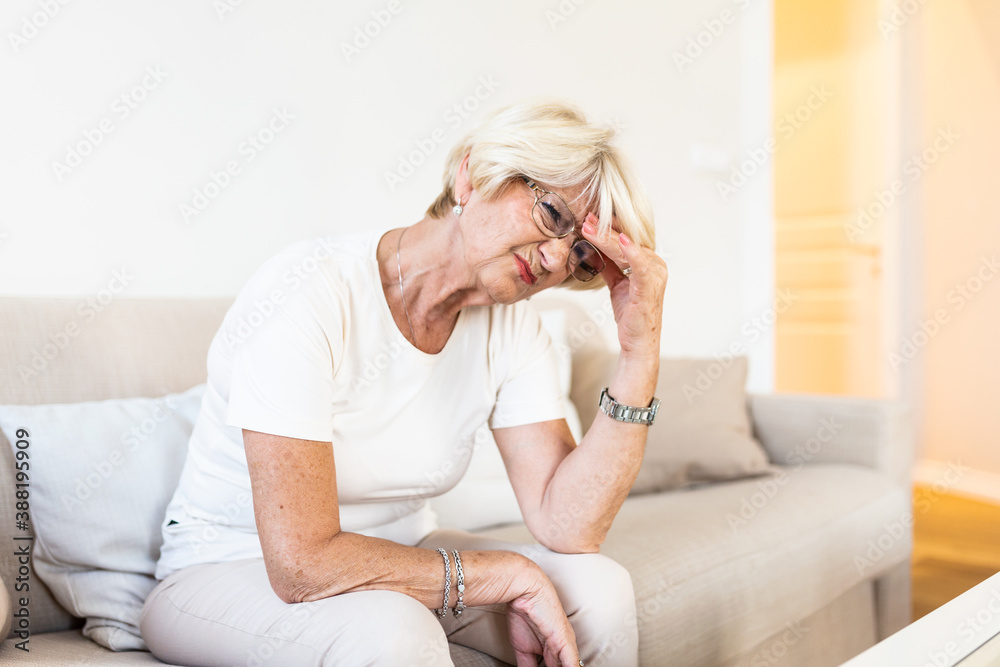 Attack of the monster migraine. Sinus pain. Unhappy Retired Senior Woman holding her head with pain expression . Face of senior woman suffering from headache