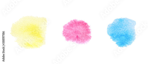 Watercolor dots of yellow, red and blue color on white background.