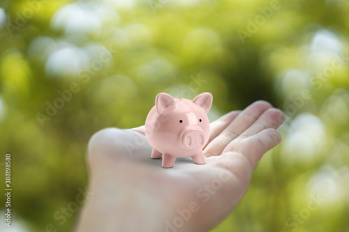 Piggy Bank in holding hand. saving money concept.