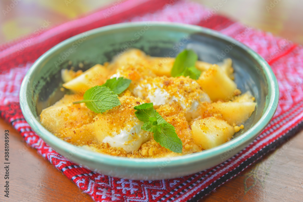 Delicious melon ice cream seved in a bowl over red table cloth. Sweet milk and fruit dessert for hot summer weather. Delicious melon ice cream seved in a bowl over red table cloth. Sweet milk and fruit dessert for hot summer weather.