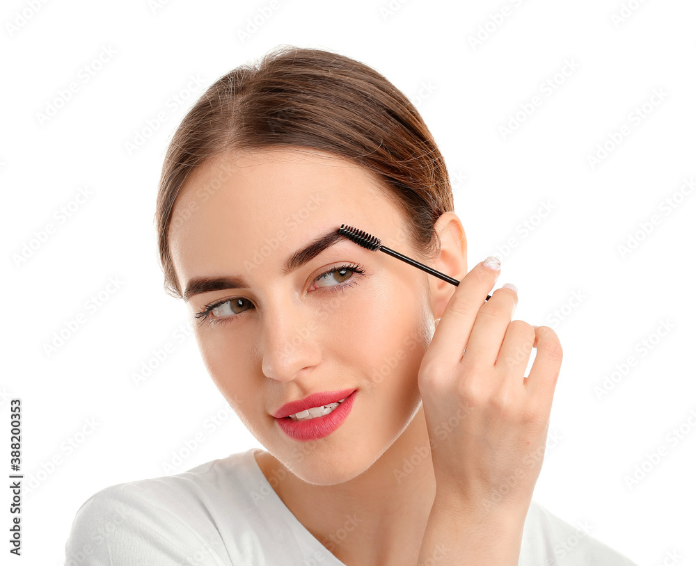 Young woman undergoing eyebrow correction procedure on white background Young woman undergoing eyebrow correction procedure on white background