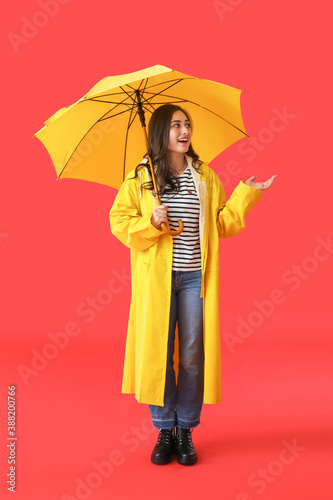 Stylish young woman in rain...