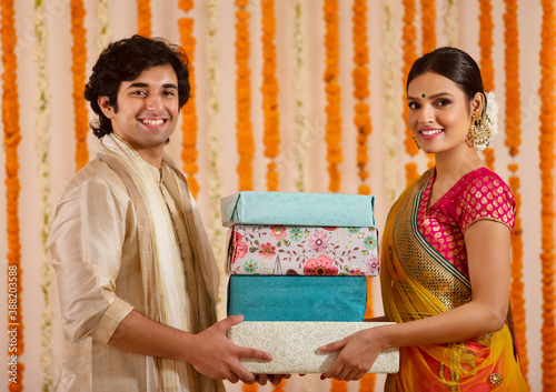 Handsome man exchanging gifts with a beautiful woman	