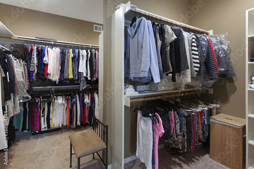 Master closet with clothes hanging