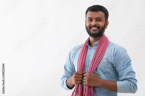 PORTRAIT OF A RURAL MAN SMILING AND POSING IN FRONT OF CAMERA

