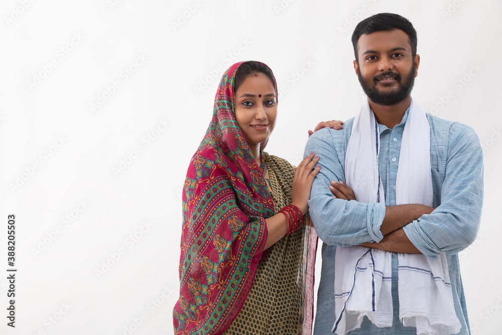 PORTRAIT OF A RURAL HUSBAND AND WIFE POSING IN FRONT OF CAMERA
