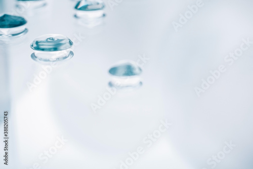 Drops of gel on a mirror surface. Background for the banner. Selective focus.