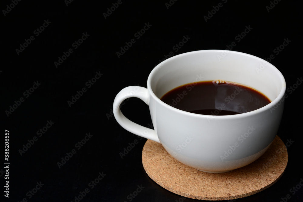 BLACK COFFEE IN WHITE CUP, ISOLATED ON NATURAL BACKGROUND