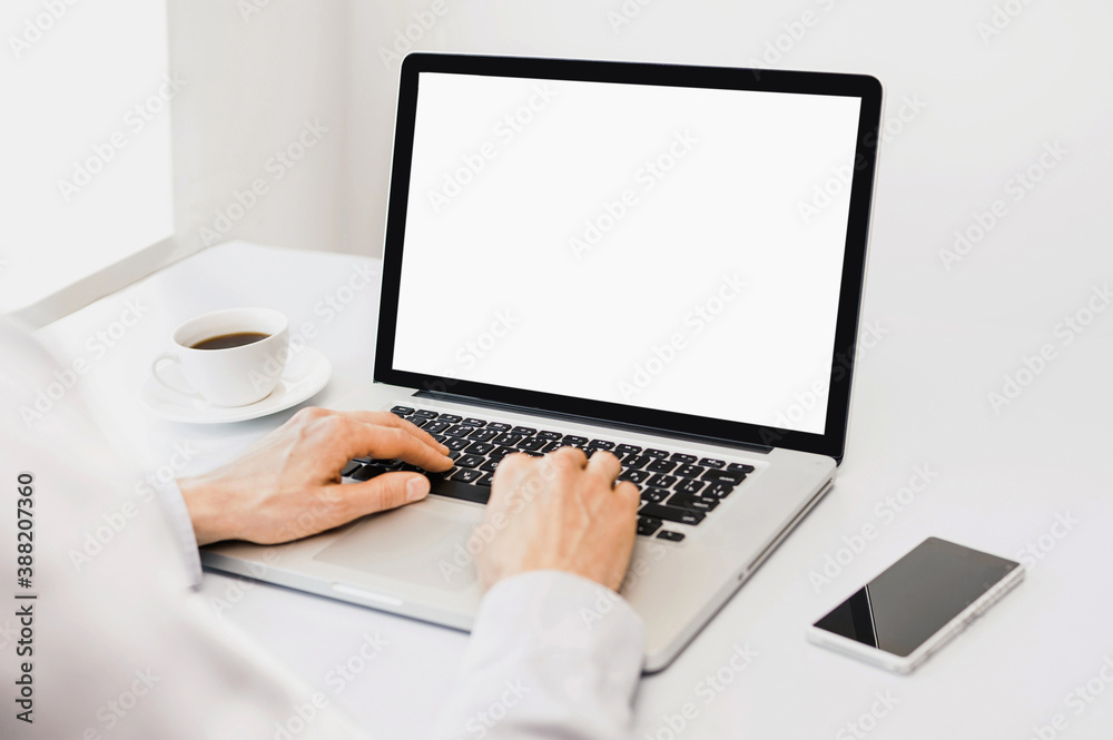 Young man professional working in office, businessman using laptop computer with blank empty screen, work or studying from home, freelance, online learning, distance education concept - obrazy, fototapety, plakaty 