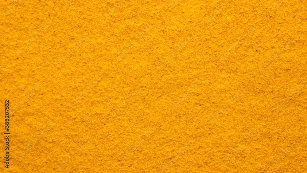 turmeric powder top view rotating. Condiment or dietary supplement