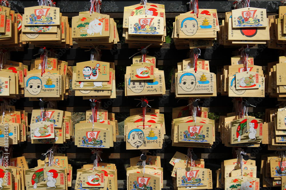 Japan - February 22, 2019: Many wooden fortune amulets
hanging with wish of people handwritten on wall in Japanese temple or shrine at Tokyo, Japan. Pattern of object, Faith or belief and Religion. 