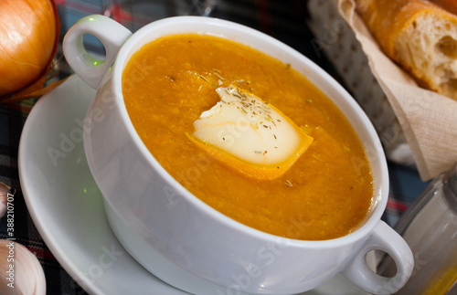 Light pumpkin cream soup with cheese and herbs