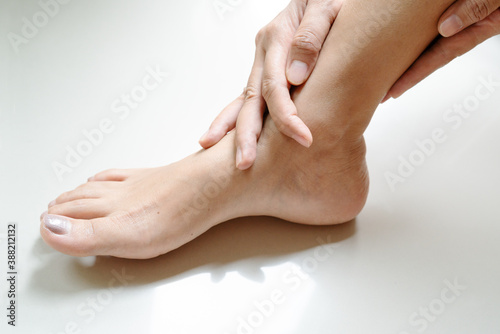women leg ankle injury/painful, women touch the pain ankle leg © PORNCHAI SODA