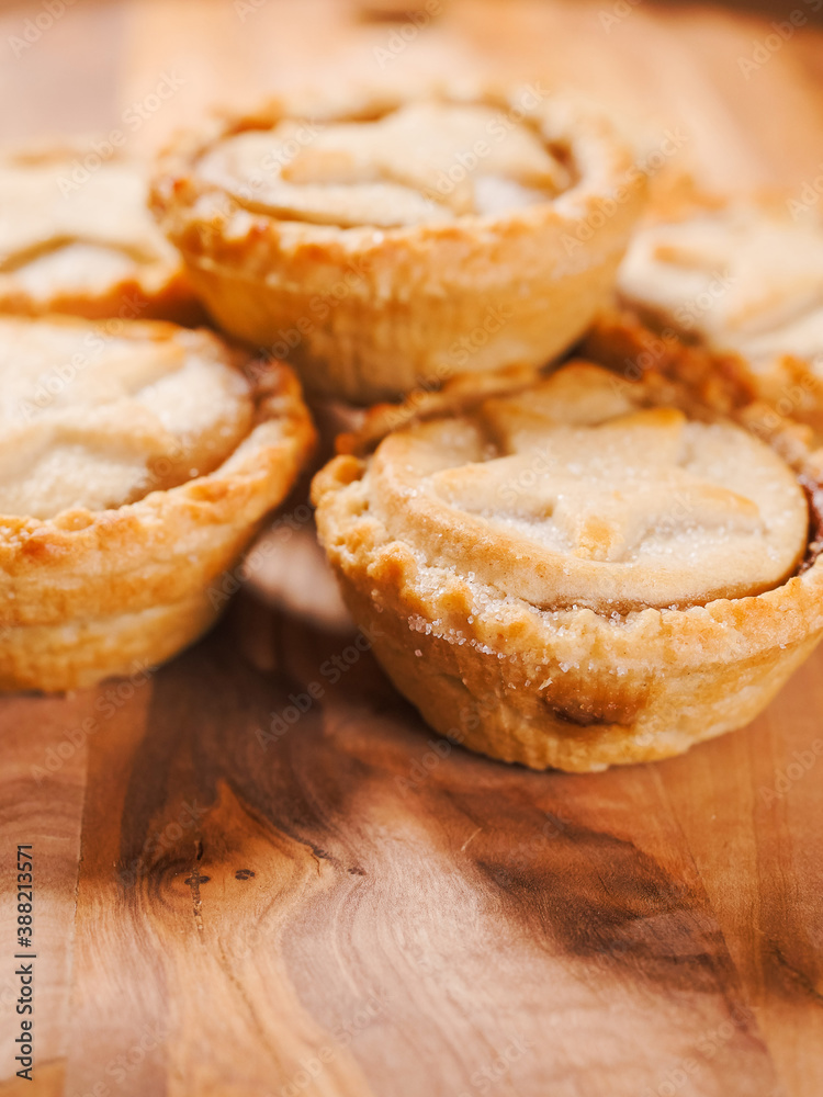 .Traditional mince pie pastry on a wooden table. Popular Christmas season dessert. Close up