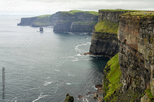 View on Cliff of Moher, structure of the cliff visible. Cloudy sky, Calm Atlantic ocean
