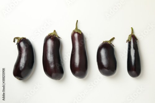 Concept of raw vegetables with eggplants on white background