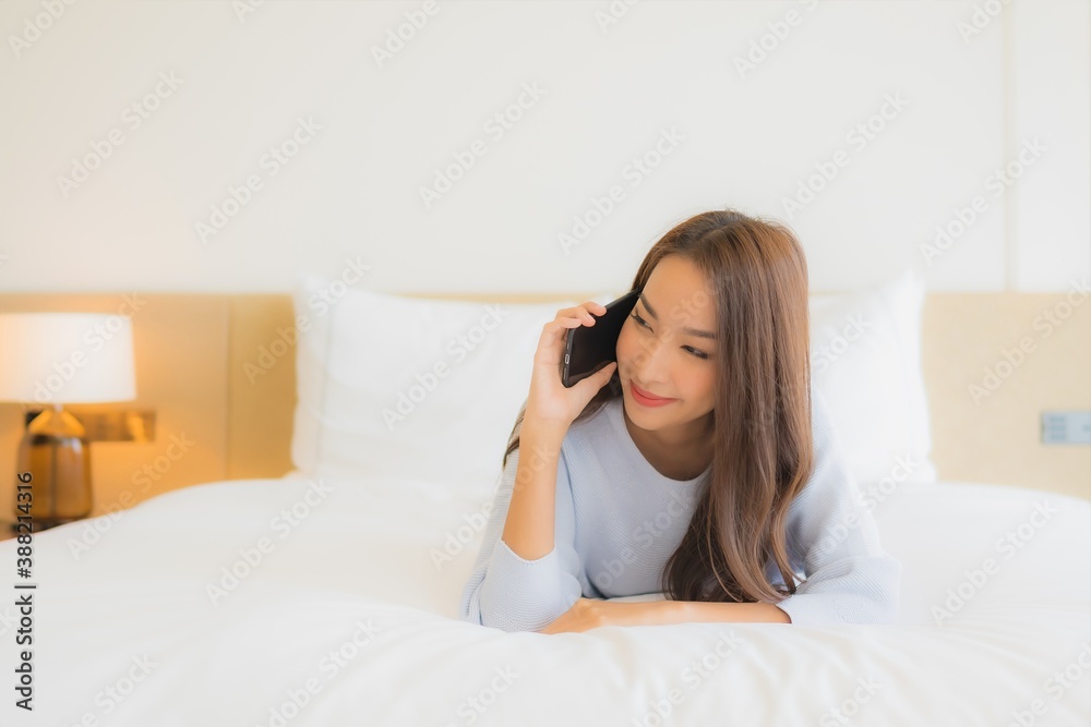 Portrait beautiful young asian woman use smart mobile phone on bed Portrait beautiful young asian woman use smart mobile phone on bed